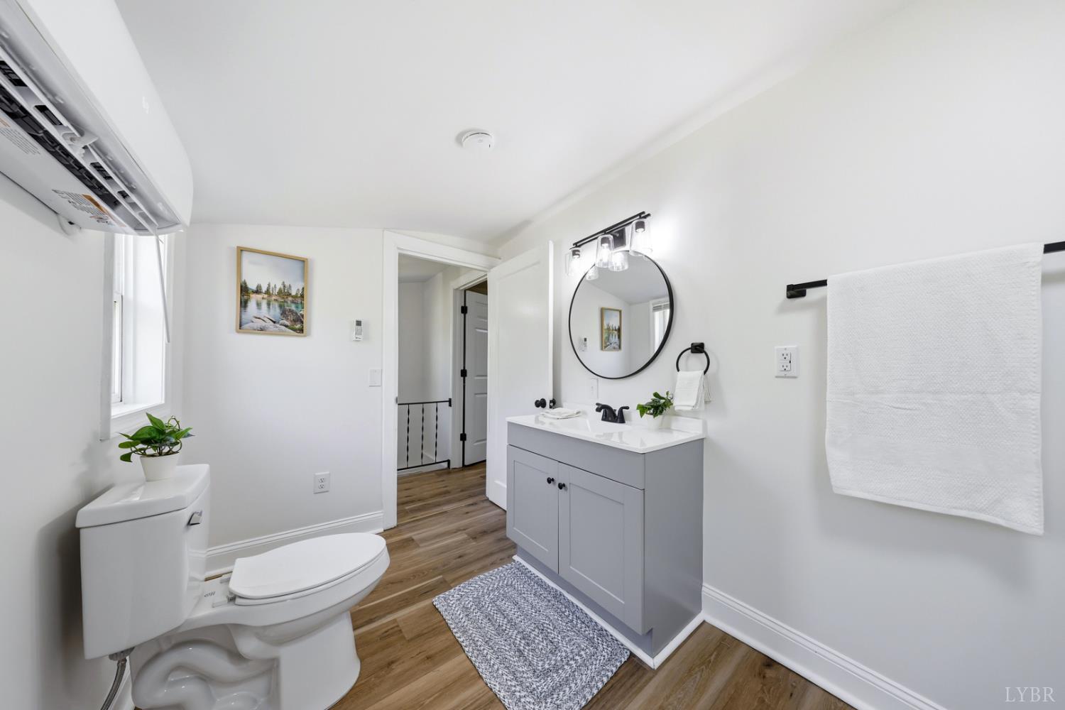 1410 Lynch Road Altavista, VA 24517 - Photo 17 of 34 a room with a toilet a sink and a mirror