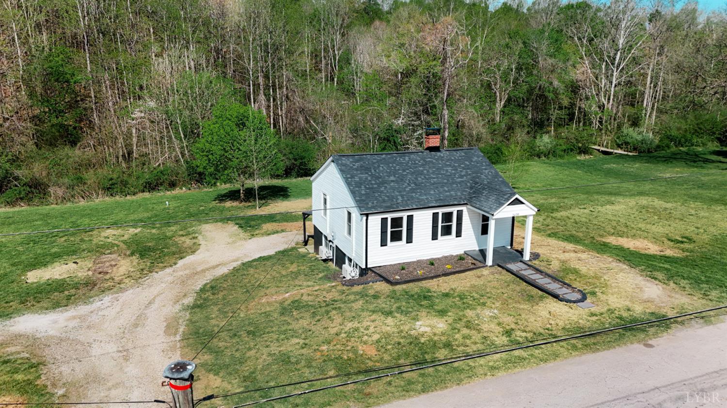 1410 Lynch Road Altavista, VA 24517 - Photo 32 of 34 an aerial view of a house with yard and trees in the background