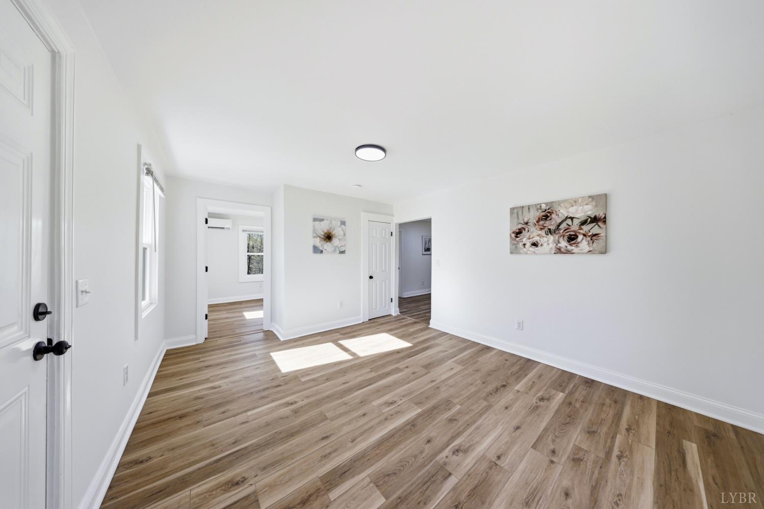 1410 Lynch Road Altavista, VA 24517 - Photo 4 of 34 a view of an empty room with wooden floor