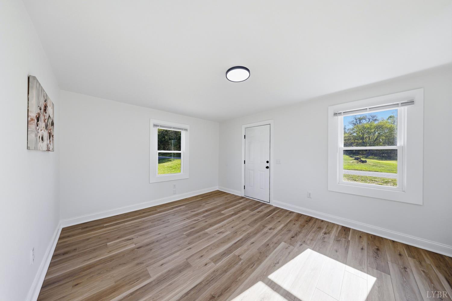 1410 Lynch Road Altavista, VA 24517 - Photo 5 of 34 a view of empty room with wooden floor and window