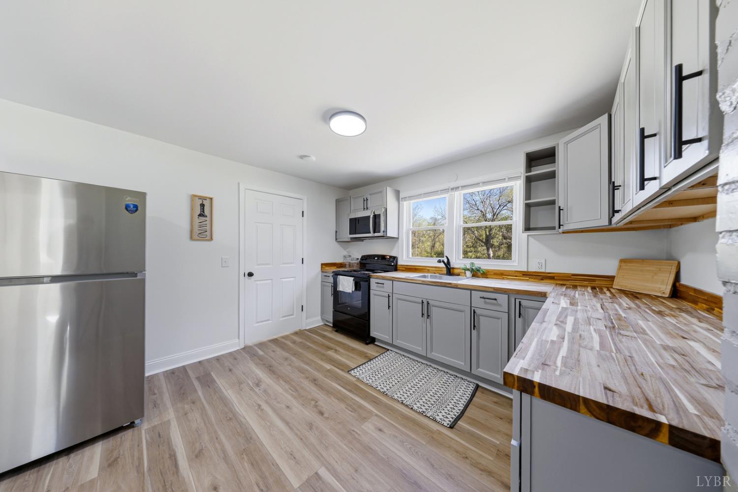 1410 Lynch Road Altavista, VA 24517 - Photo 8 of 34 a kitchen with a refrigerator and a sink