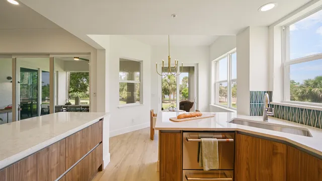 a kitchen with stainless steel appliances granite countertop a sink a stove and a refrigerator
