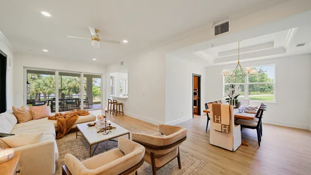 a living room with furniture fireplace and wooden floor