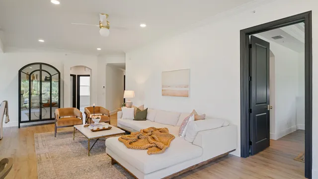 a living room with furniture a window and a chandelier