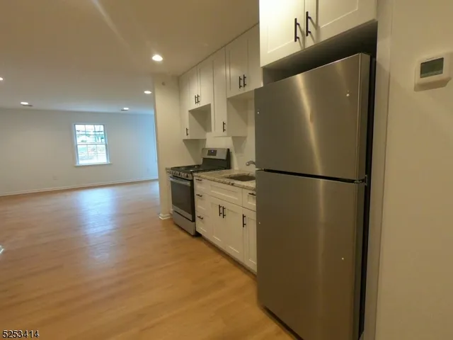 a kitchen with stainless steel appliances a refrigerator sink and cabinets
