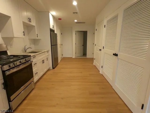 a kitchen with stainless steel appliances granite countertop a stove and a refrigerator
