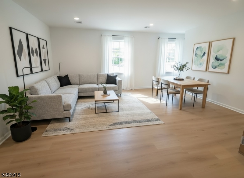 588 Springfield Avenue, Unit 1 Berkeley Heights, NJ 07922 - Photo 9 of 12 a living room with furniture and a large window