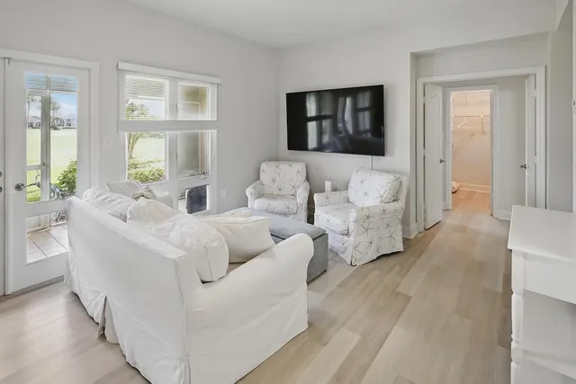 a living room with couches and painting on the wall