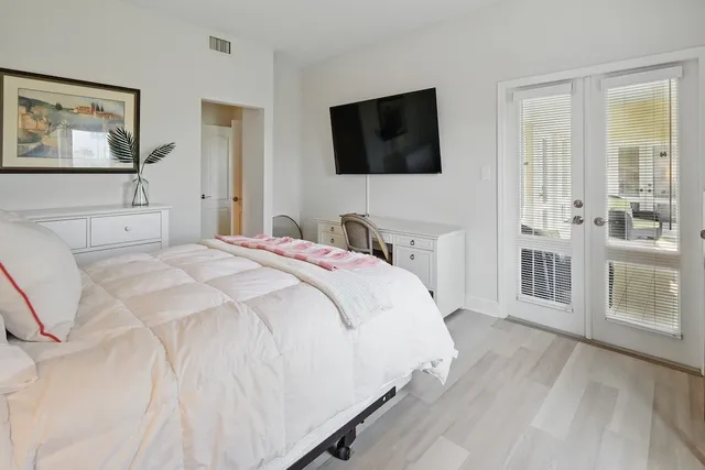 a bedroom with a bed and a flat screen tv