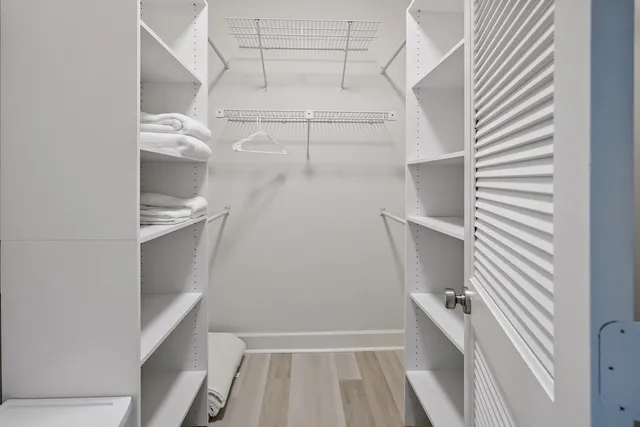 a view of walk in closet with empty racks