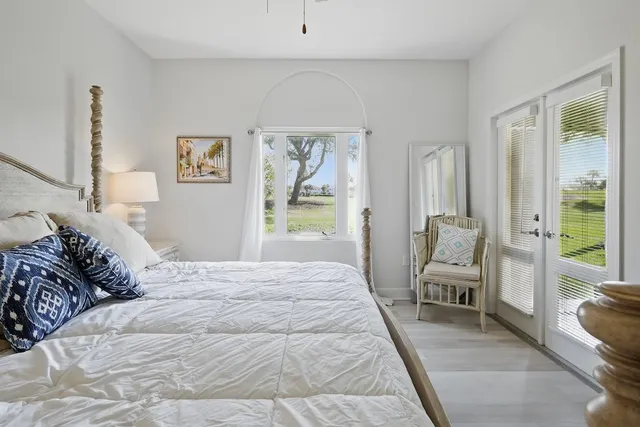 a bedroom with a large bed and a large window