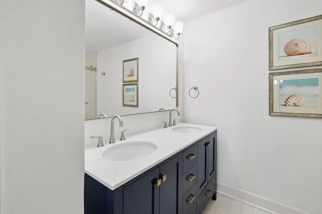 a bathroom with a sink vanity and a mirror