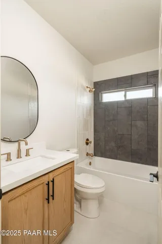 an empty room with a window and a ceiling fan