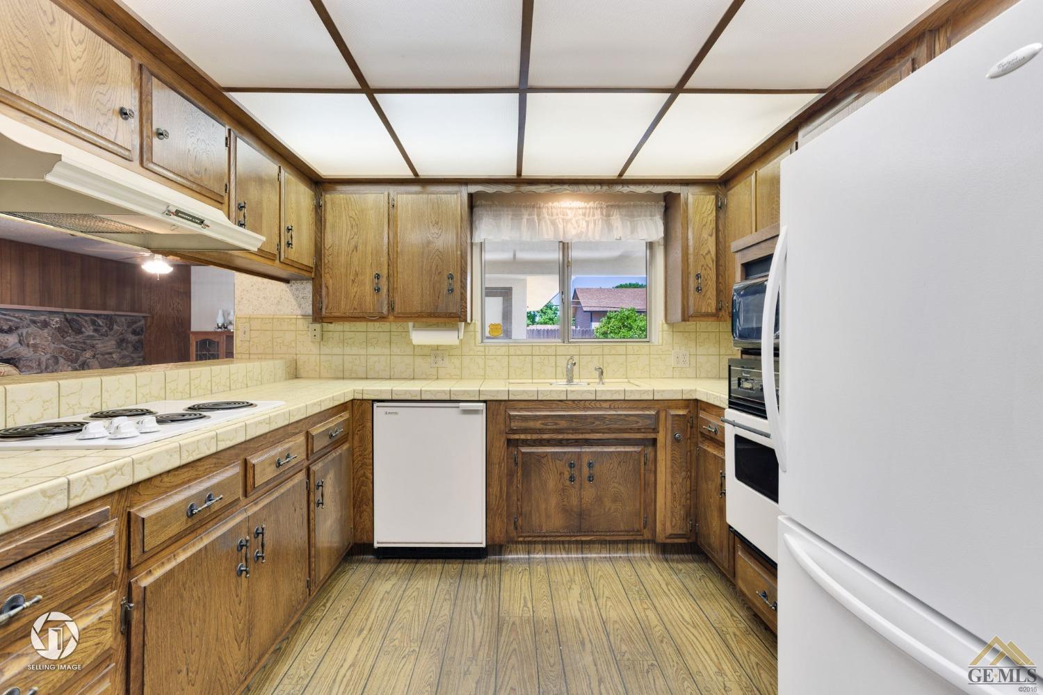 Undisclosed Address Bakersfield, CA 93308 - Photo 15 of 45 a kitchen with stainless steel appliances granite countertop a sink and cabinets