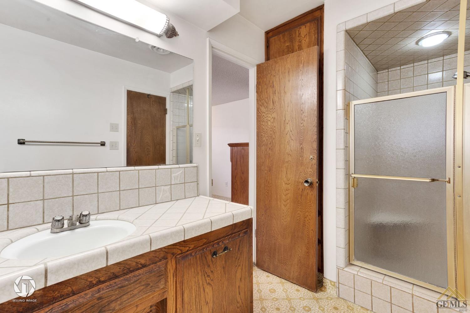 Undisclosed Address Bakersfield, CA 93308 - Photo 23 of 45 a bathroom with a sink and a mirror