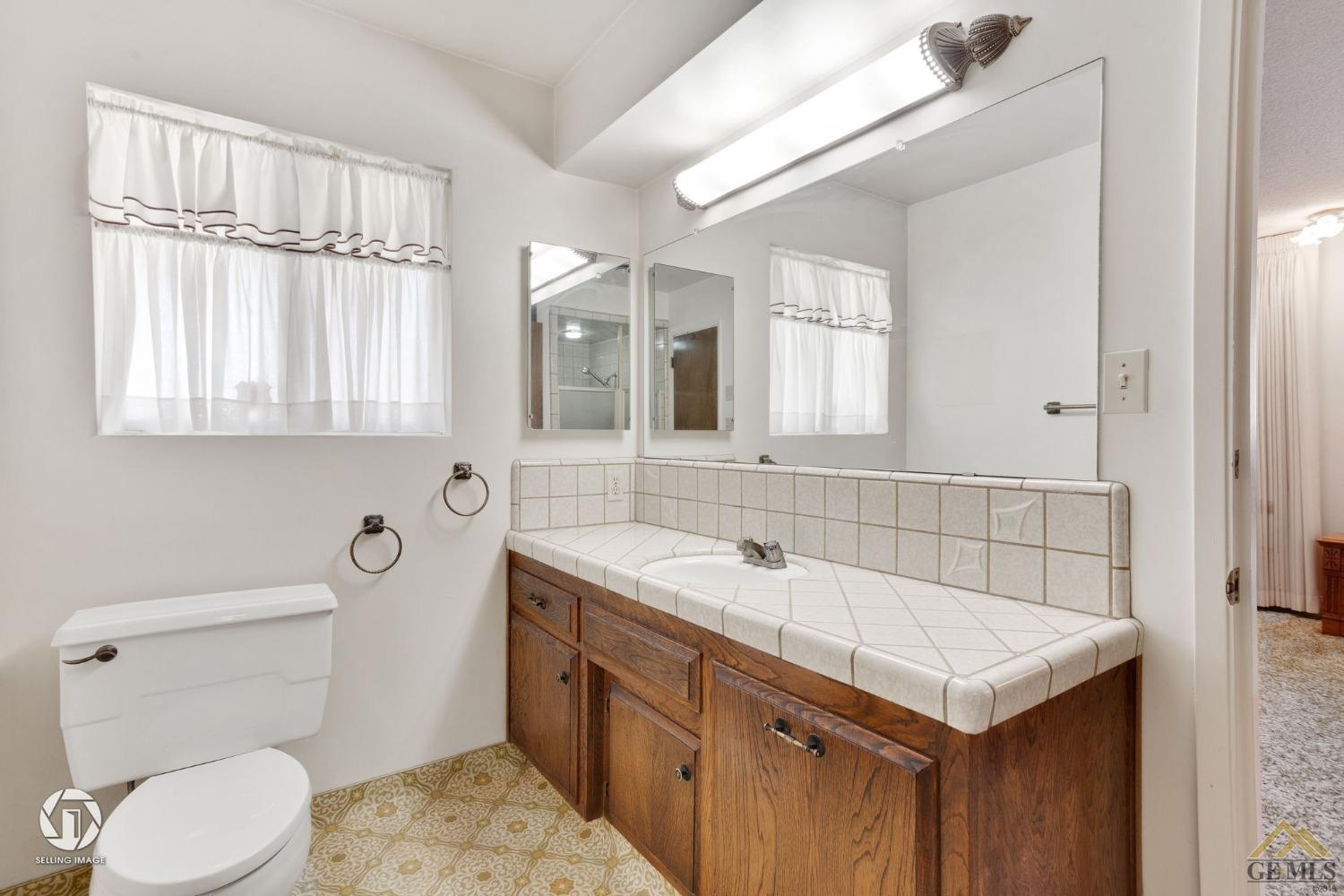 Undisclosed Address Bakersfield, CA 93308 - Photo 24 of 45 a bathroom with a sink and a toilet