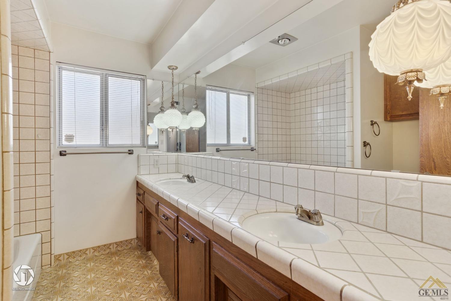 Undisclosed Address Bakersfield, CA 93308 - Photo 27 of 45 a bathroom with a sink and a mirror