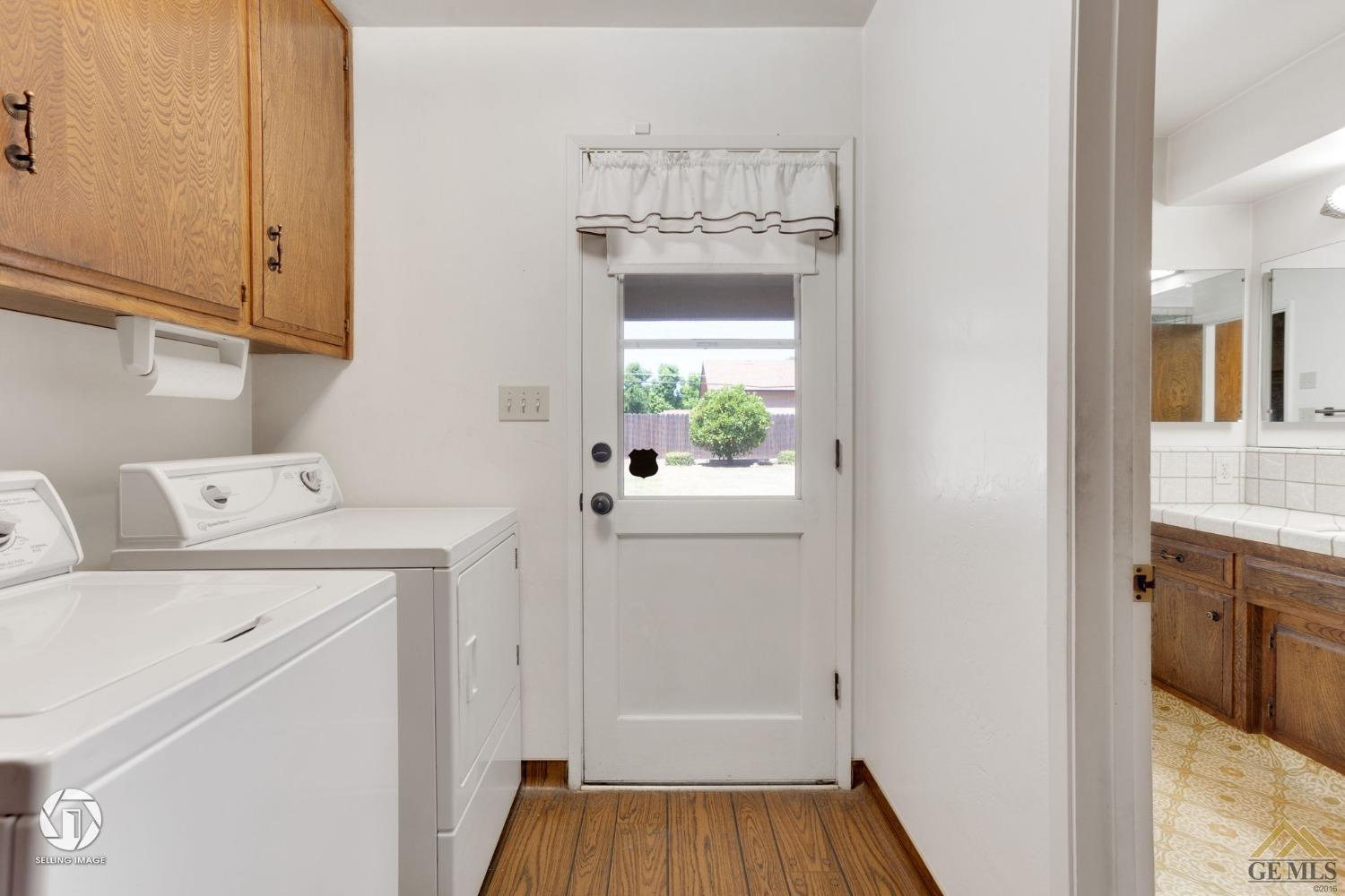 Undisclosed Address Bakersfield, CA 93308 - Photo 28 of 45 a utility room with cabinets washer and dryer