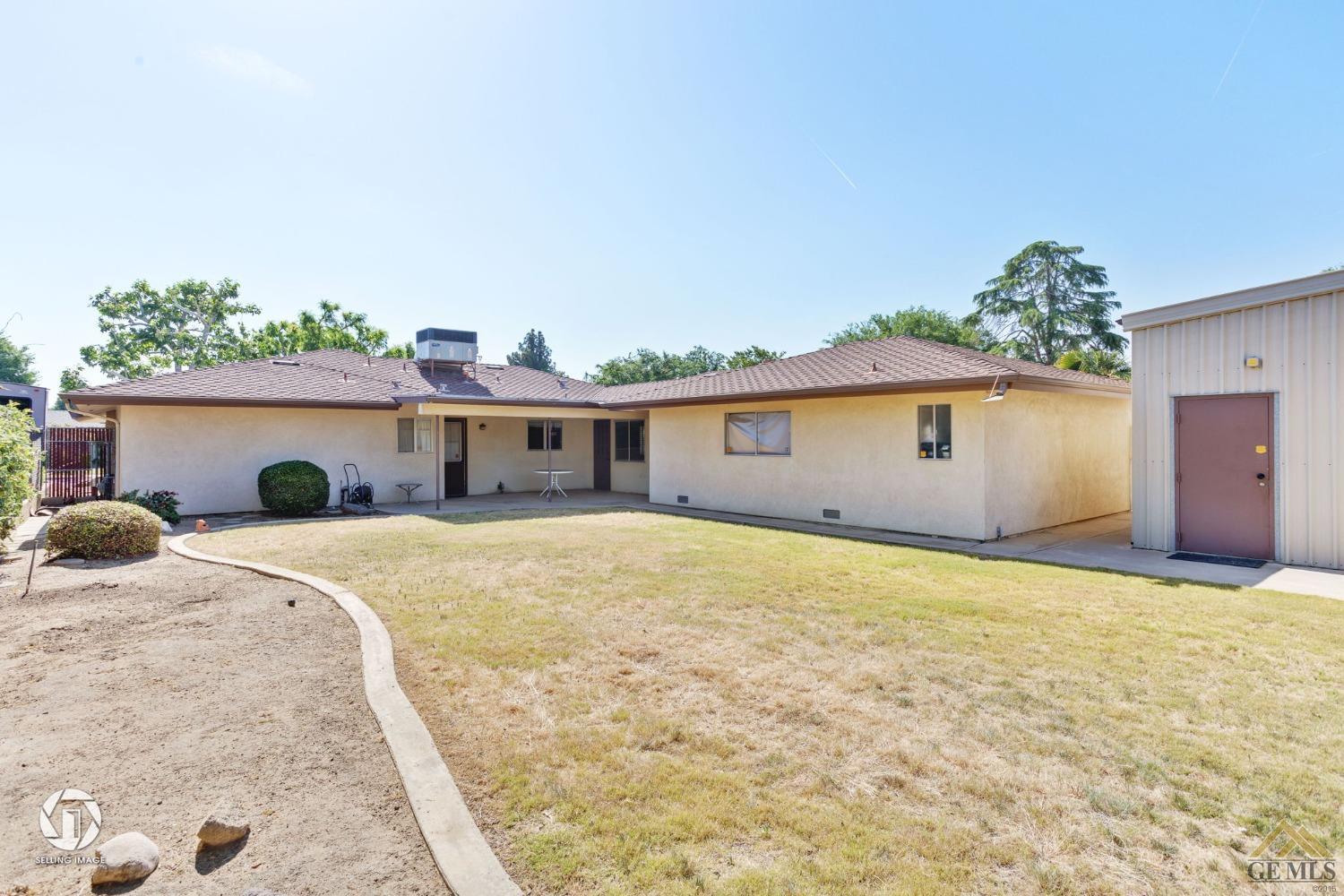 Undisclosed Address Bakersfield, CA 93308 - Photo 33 of 45 a front view of house with yard and trees in the background