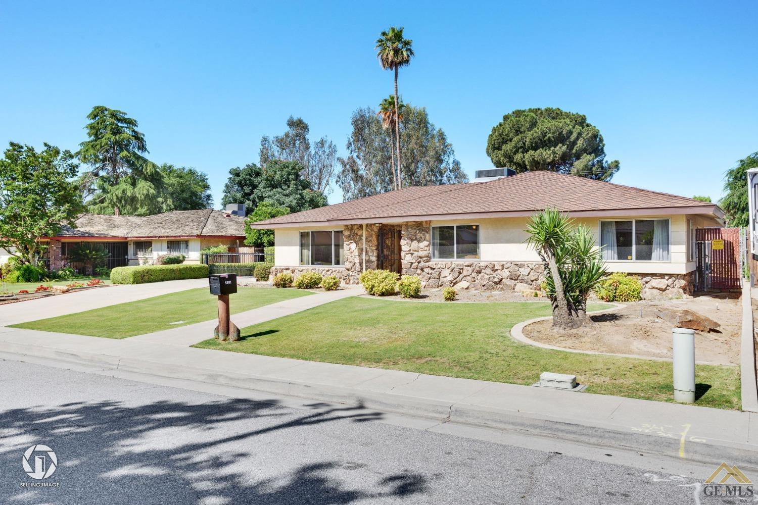 Undisclosed Address Bakersfield, CA 93308 - Photo 6 of 45 a front view of a house with a yard