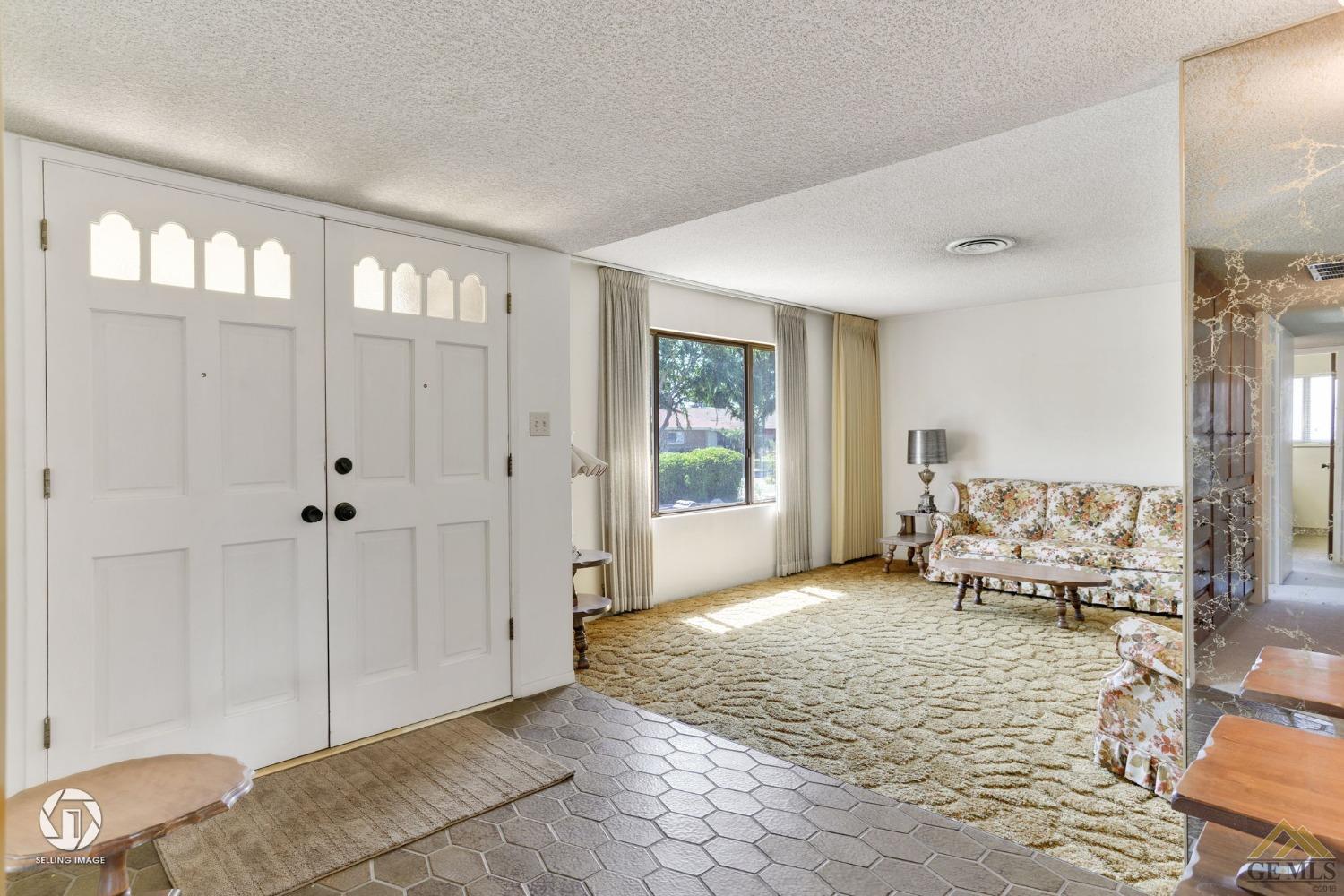 Undisclosed Address Bakersfield, CA 93308 - Photo 10 of 45 a view of an empty room with window and hardwood floor