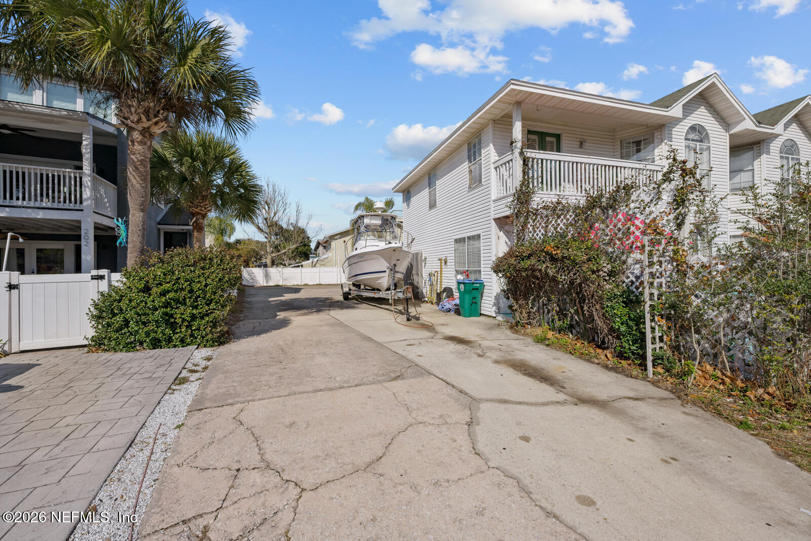 1914 First Street Neptune Beach, FL 32266 - Photo 15 of 55 a front view of a house with a yard and potted plants