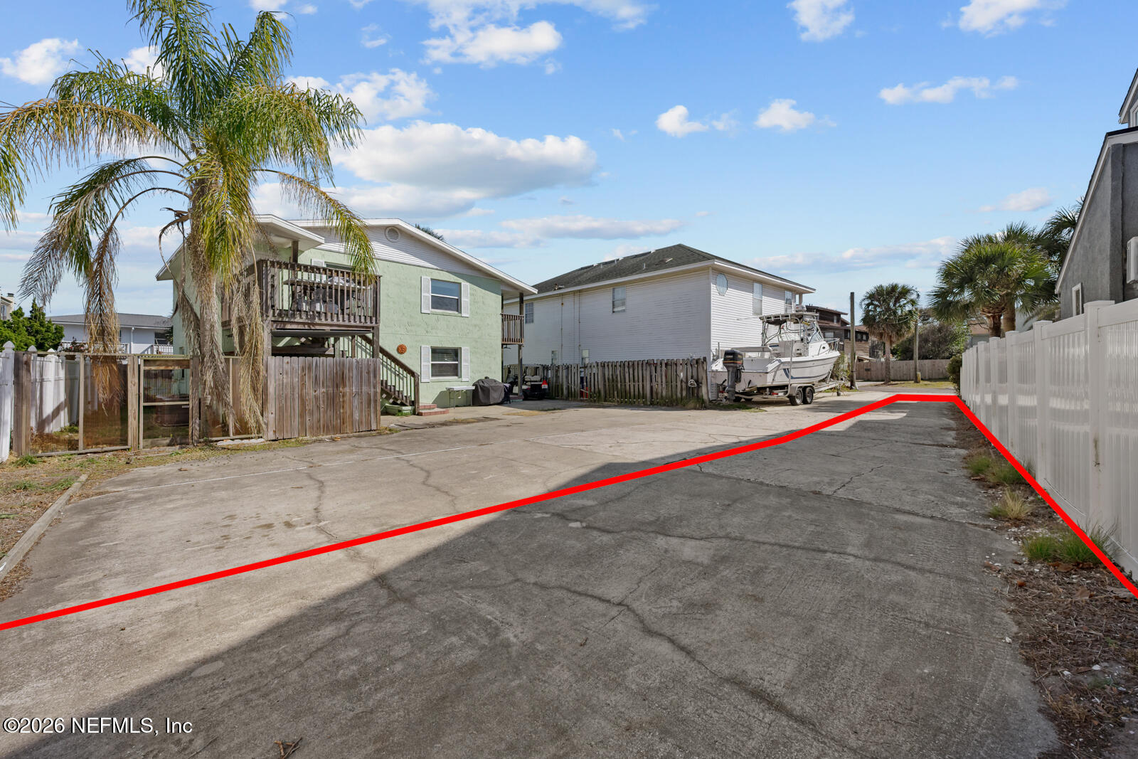 1914 First Street Neptune Beach, FL 32266 - Photo 51 of 55 a white house with a small yard and palm trees