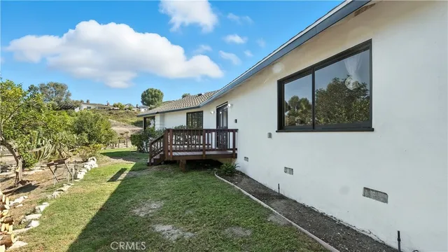 an empty room with wooden floor and a ceiling fan