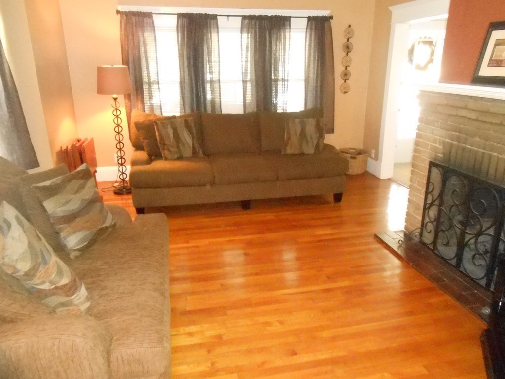32 Larkspur Street Springfield, MA 01108 - Photo 2 of 26 a living room with furniture and a fireplace
