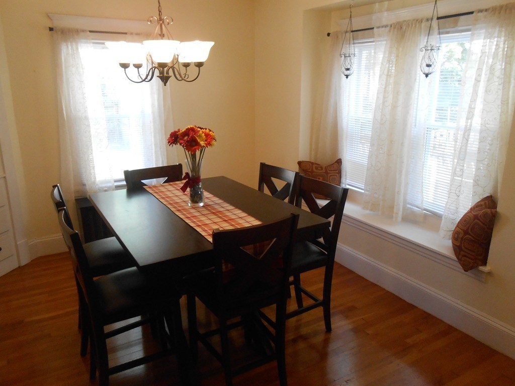 32 Larkspur Street Springfield, MA 01108 - Photo 5 of 26 a dining room with furniture a chandelier and wooden floor