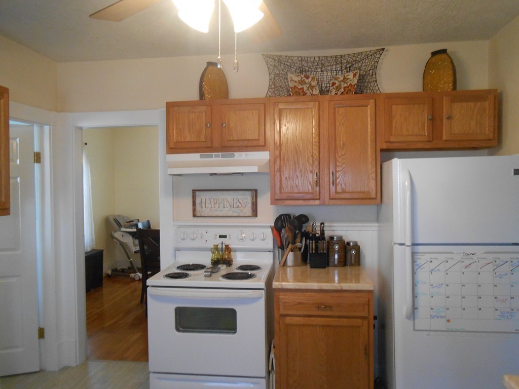 32 Larkspur Street Springfield, MA 01108 - Photo 6 of 26 a kitchen with a stove and a refrigerator