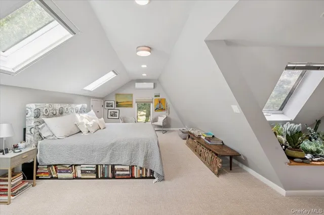 a bedroom with a bed and a potted plant on the dresser