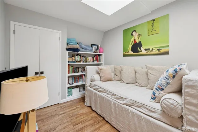 a living room with furniture and a book shelf