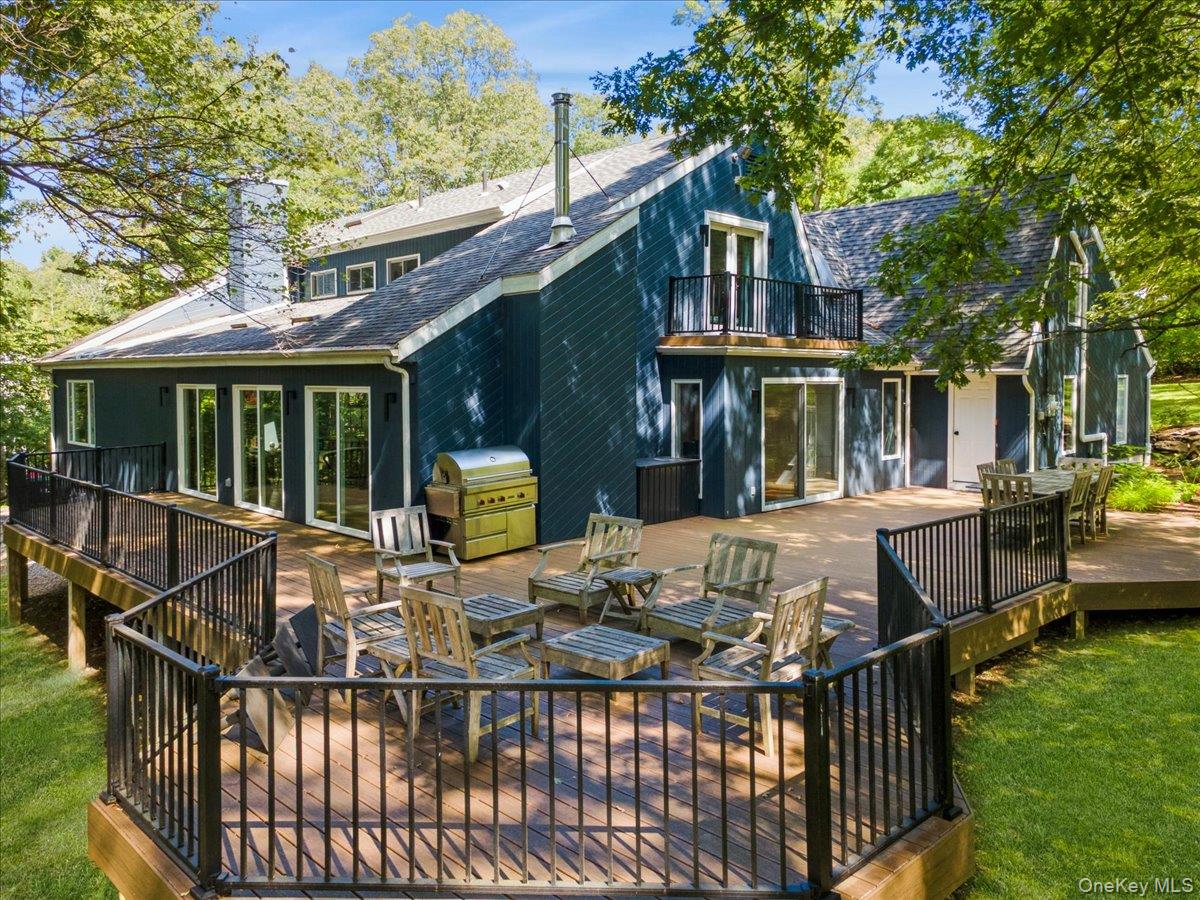 46 Ridgefield Avenue South Salem, NY 10590 - Photo 37 of 38 a view of a patio with couches chairs and a table and chairs with wooden fence