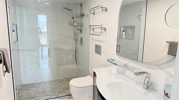 a bathroom with a sink toilet and shower