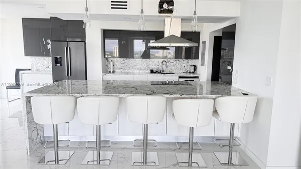 a kitchen with kitchen island granite countertop a counter top space cabinets and stainless steel appliances