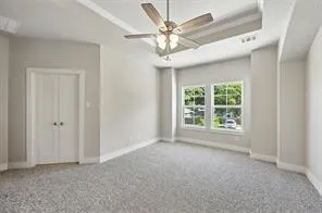 a view of a livingroom with a ceiling fan and window