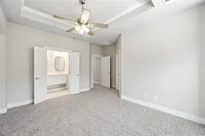 an empty room with closet and fan