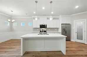 a view of a kitchen island a sink and refrigerator