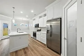 a kitchen with a sink stainless steel appliances and cabinets