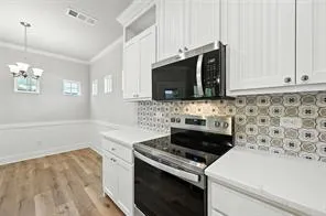 a kitchen with a stove and a microwave