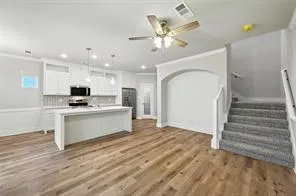 a view of kitchen with sink and refrigerator