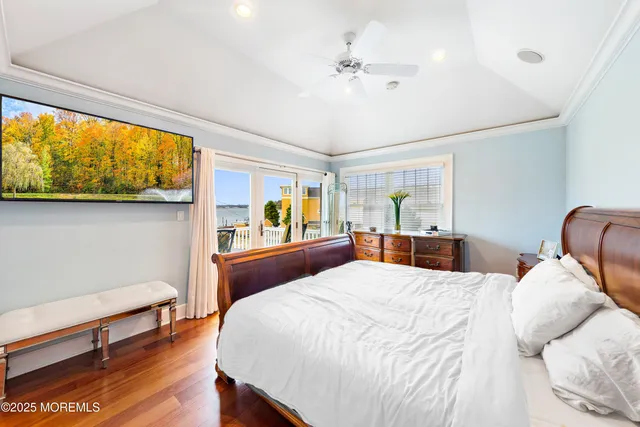 a bedroom with a large bed and a chandelier