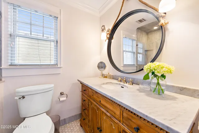a bathroom with a sink a mirror and a toilet
