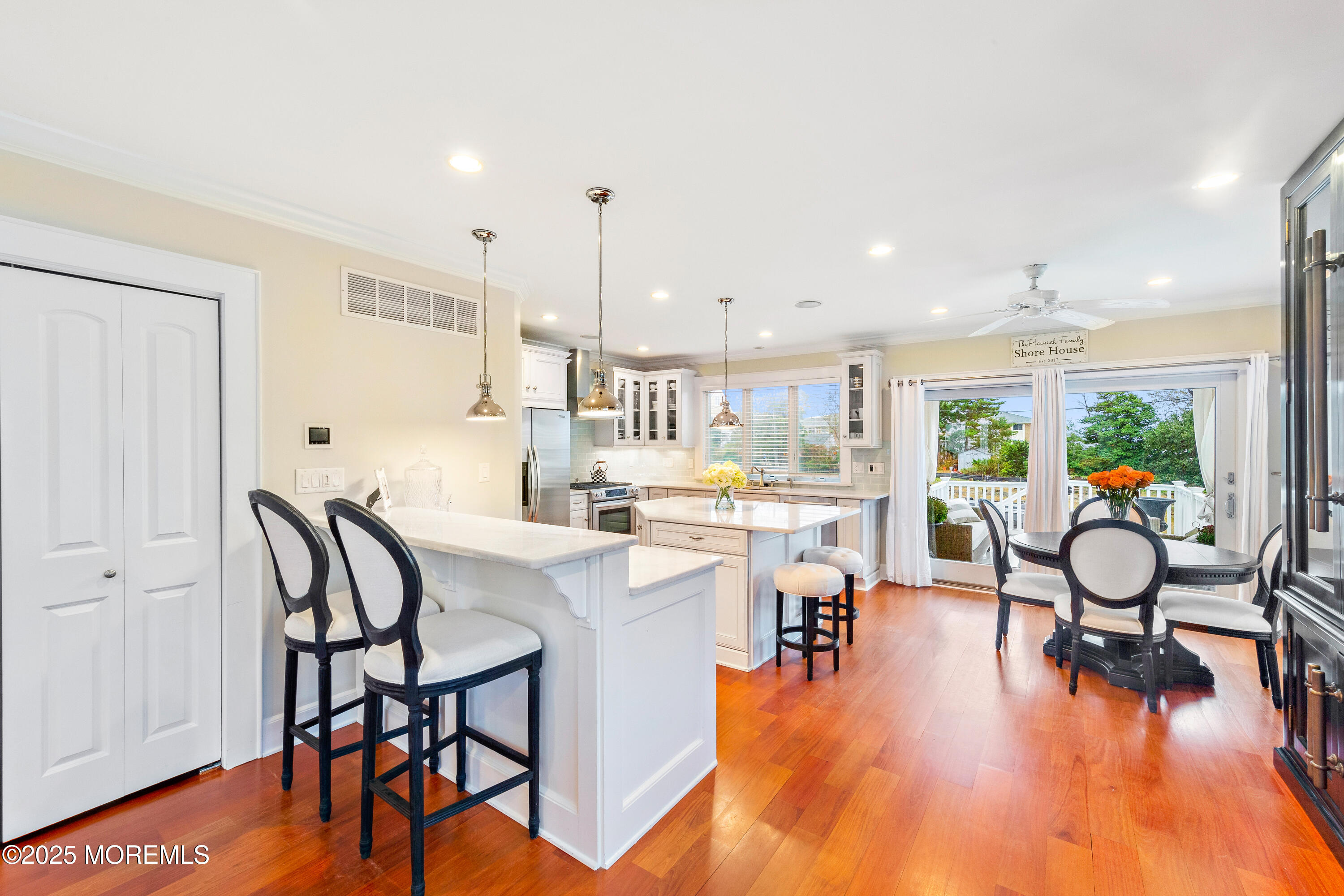 6 Via Ripa Sea Bright, NJ 07760 - Photo 4 of 25 a kitchen with a table chairs stove and wooden floor