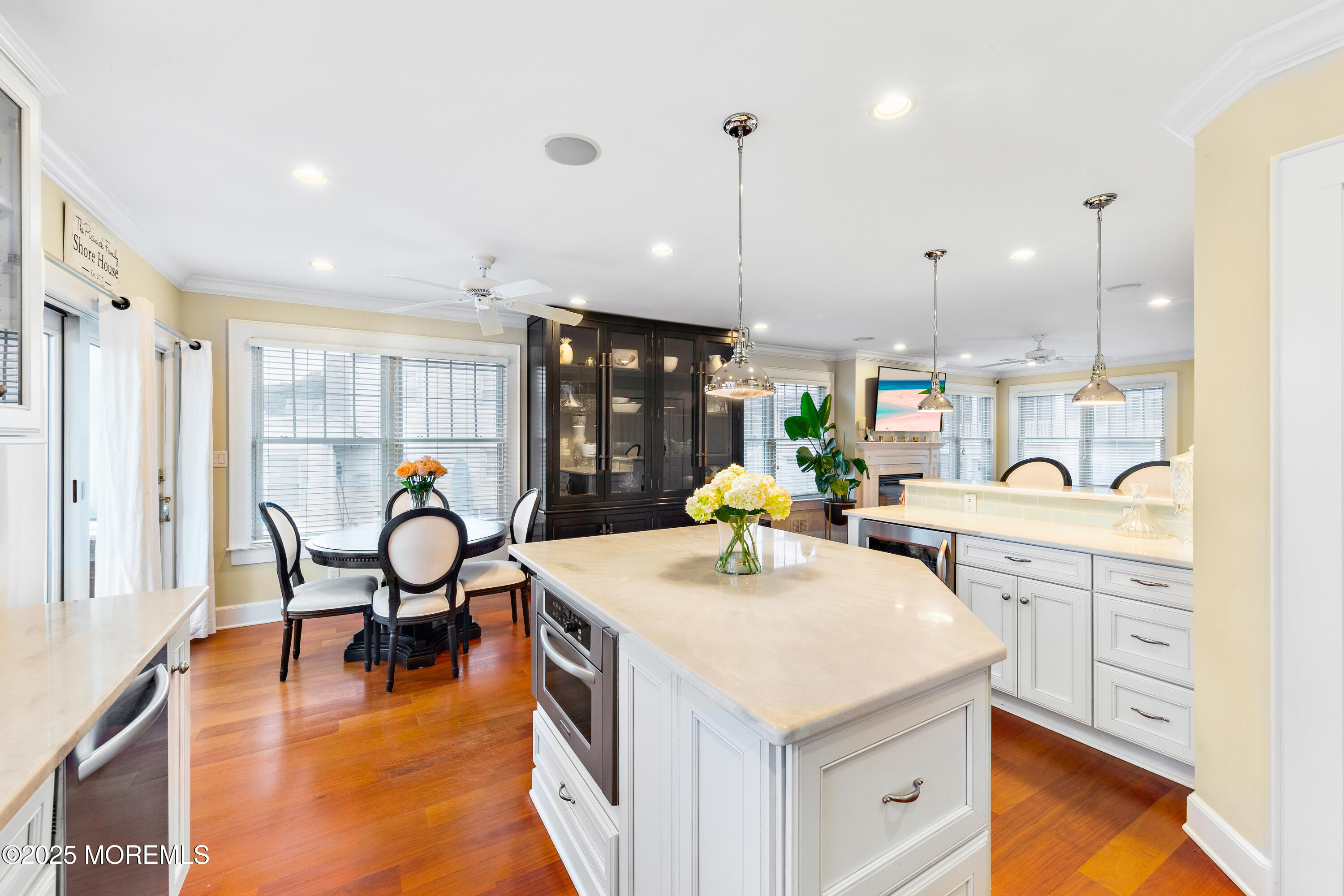 6 Via Ripa Sea Bright, NJ 07760 - Photo 9 of 25 a kitchen with a dining table chairs and sink