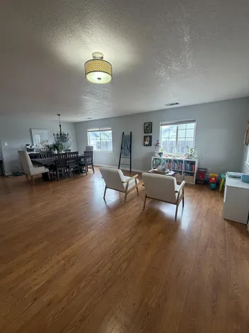 a view of a livingroom with furniture and hardwood floor