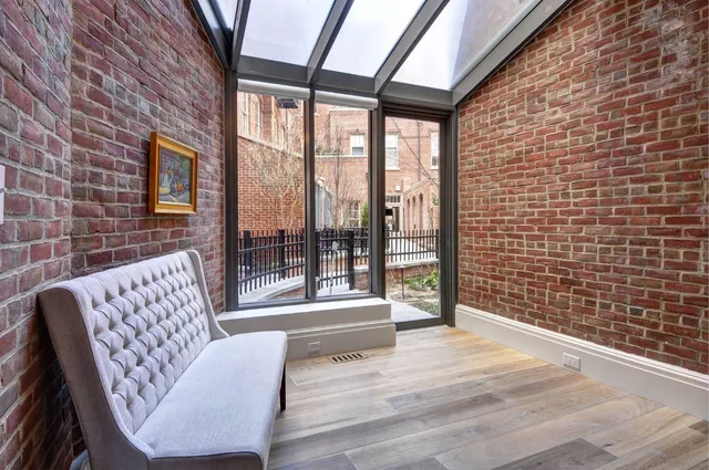 a living room with furniture and a floor to ceiling window