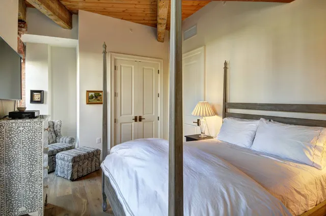 a bedroom with a bed and a couch