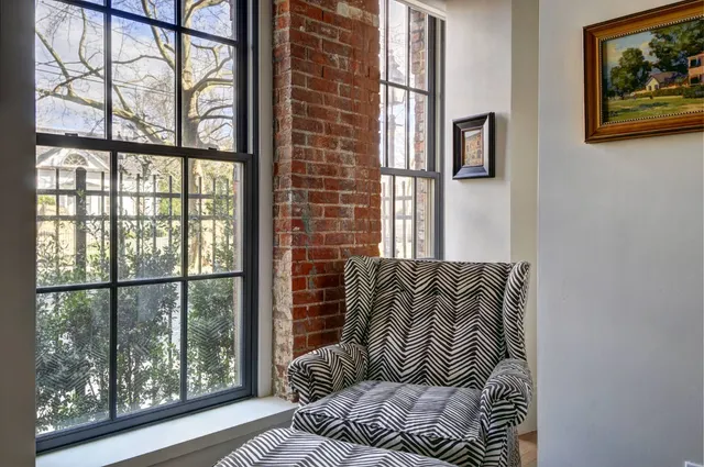 a bedroom with a large window and a bed